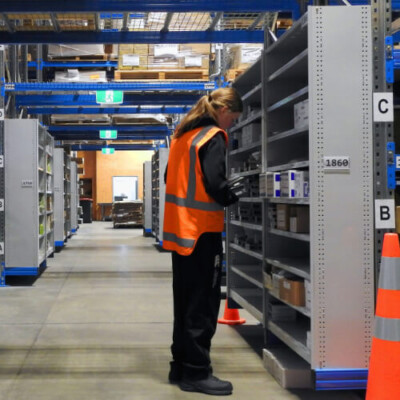 Warehouse personnel picking items from Panel End Shelves